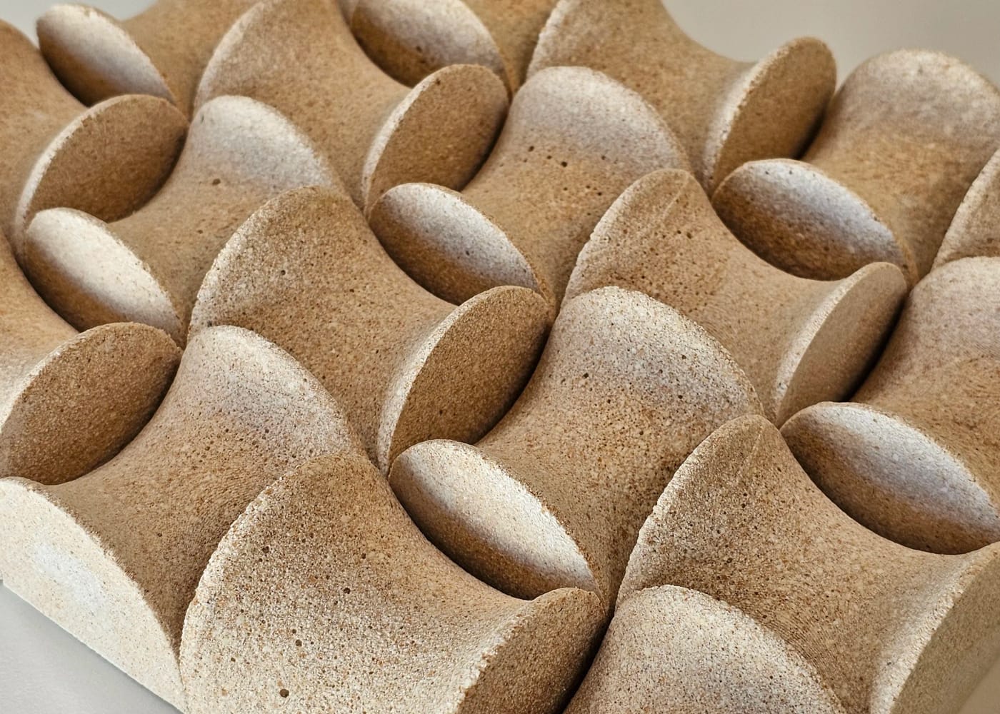 Close view of tessellated building components cast from shell waste.